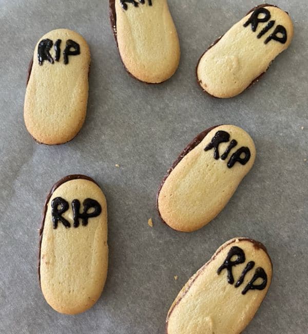 milano cookies on parchment paper with RIP written on them