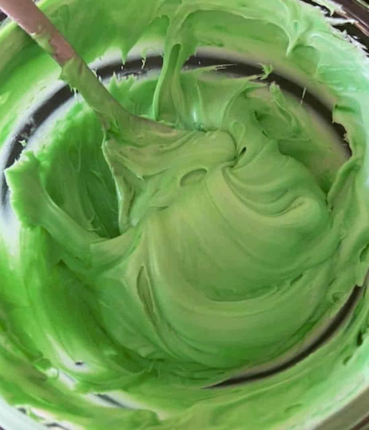 Green icing in bowl.