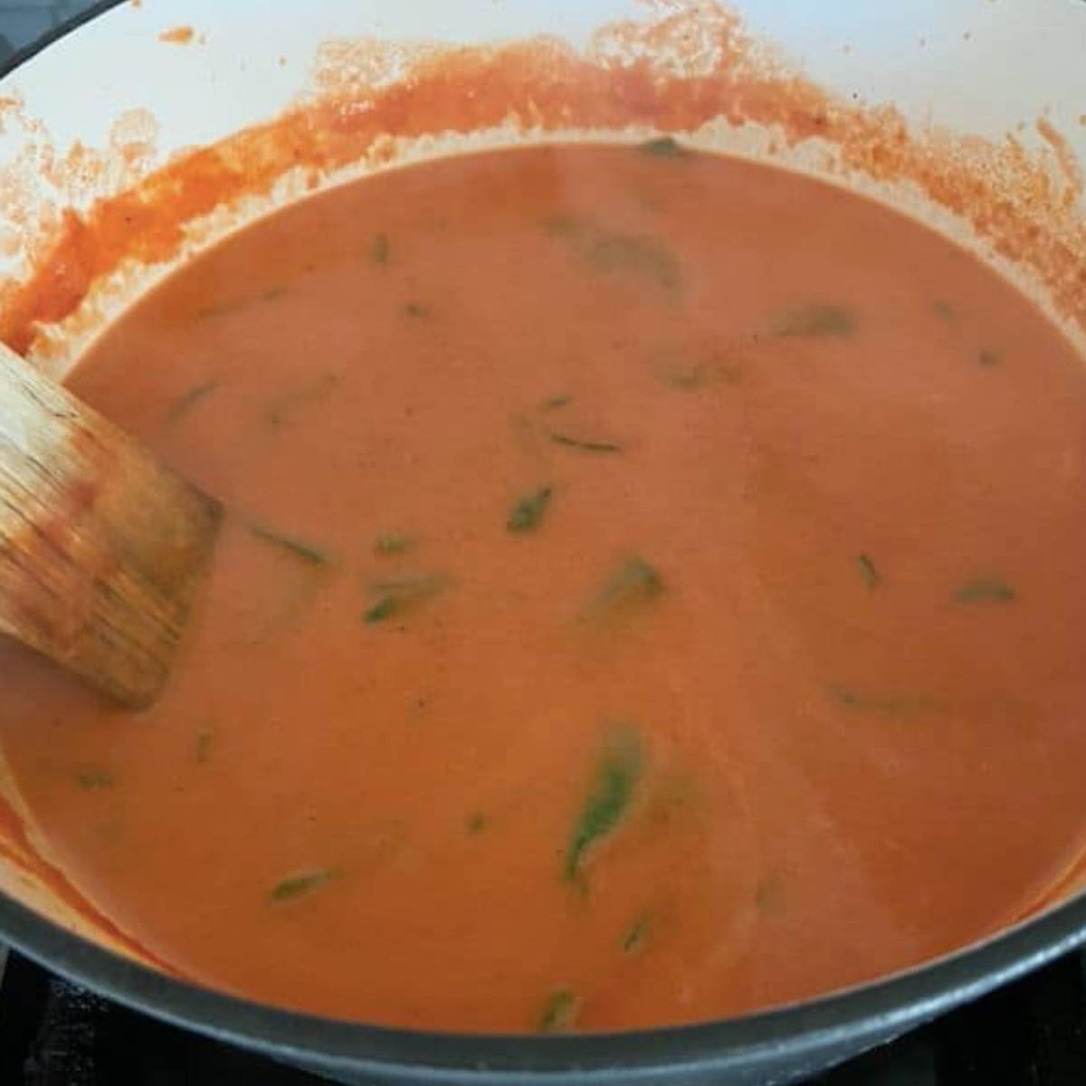 Cream and spinach in tomato soup.