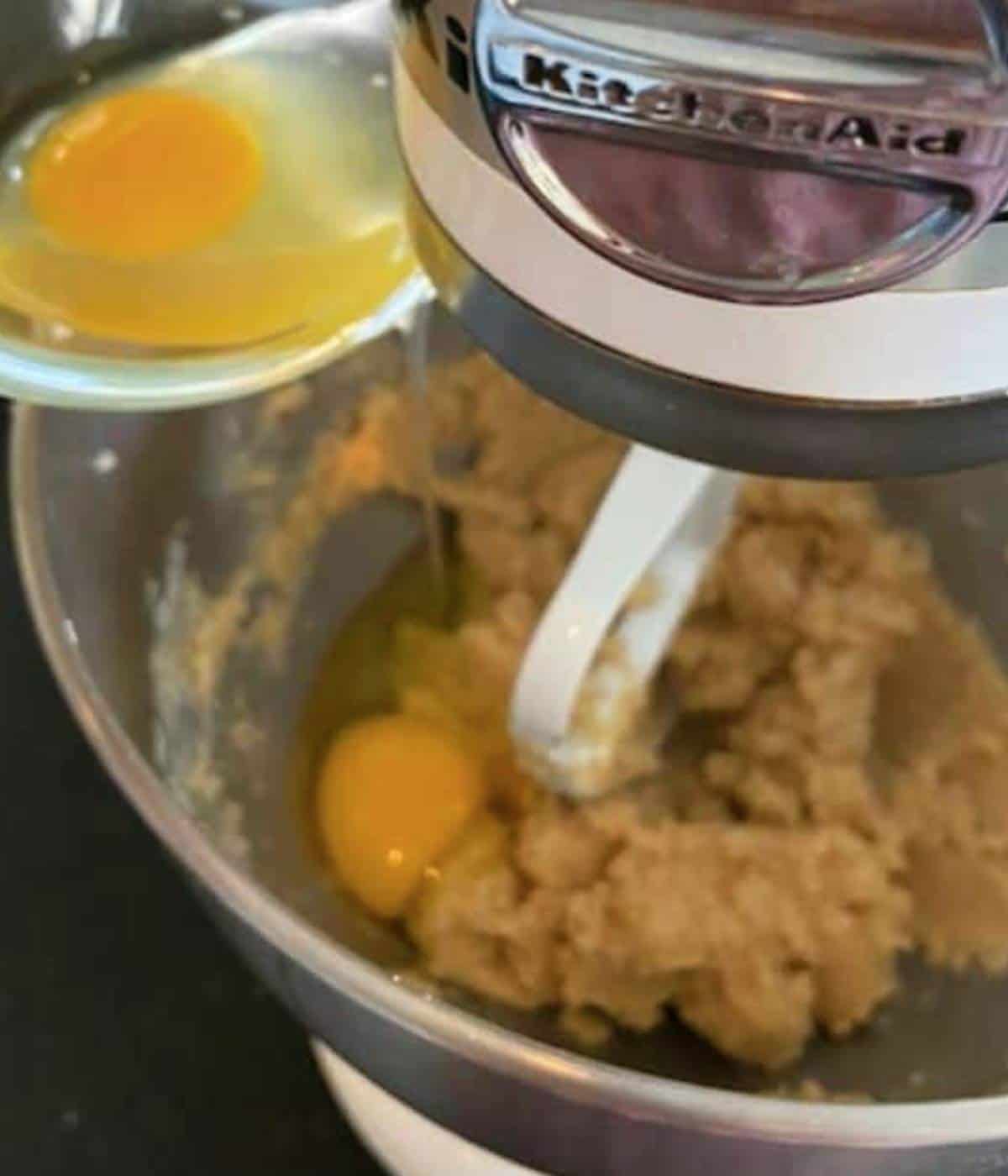 Adding eggs into mixer.