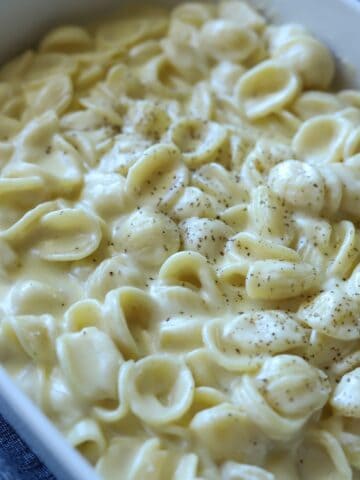 close up of white cheddar macaroni and cheese in casserole dish