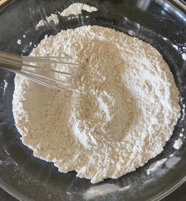 dry ingredients in glass bowl with whisk