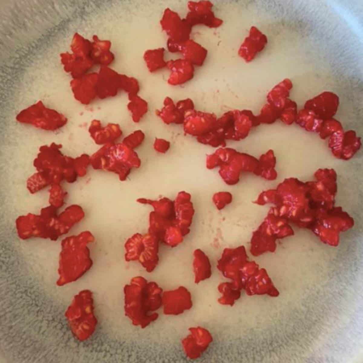 Frozen raspberries on plate. 
