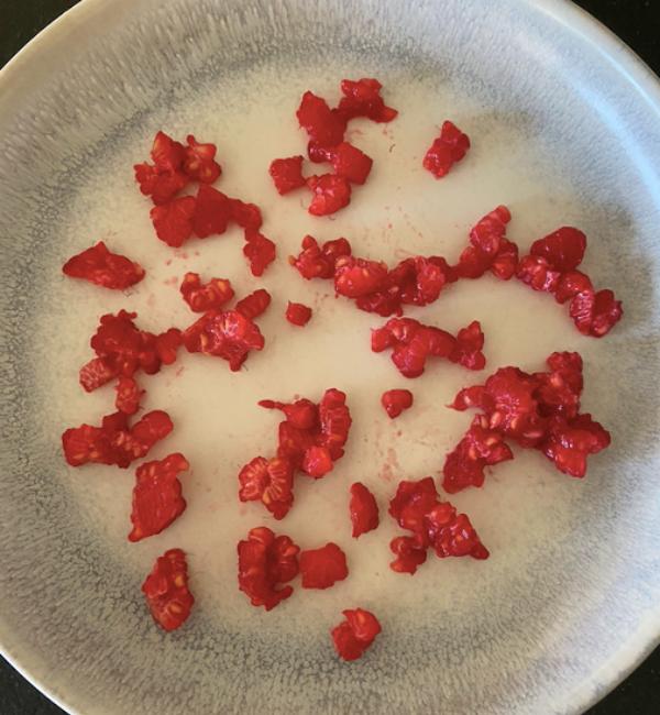 raspberries cut up into small pieces on plate