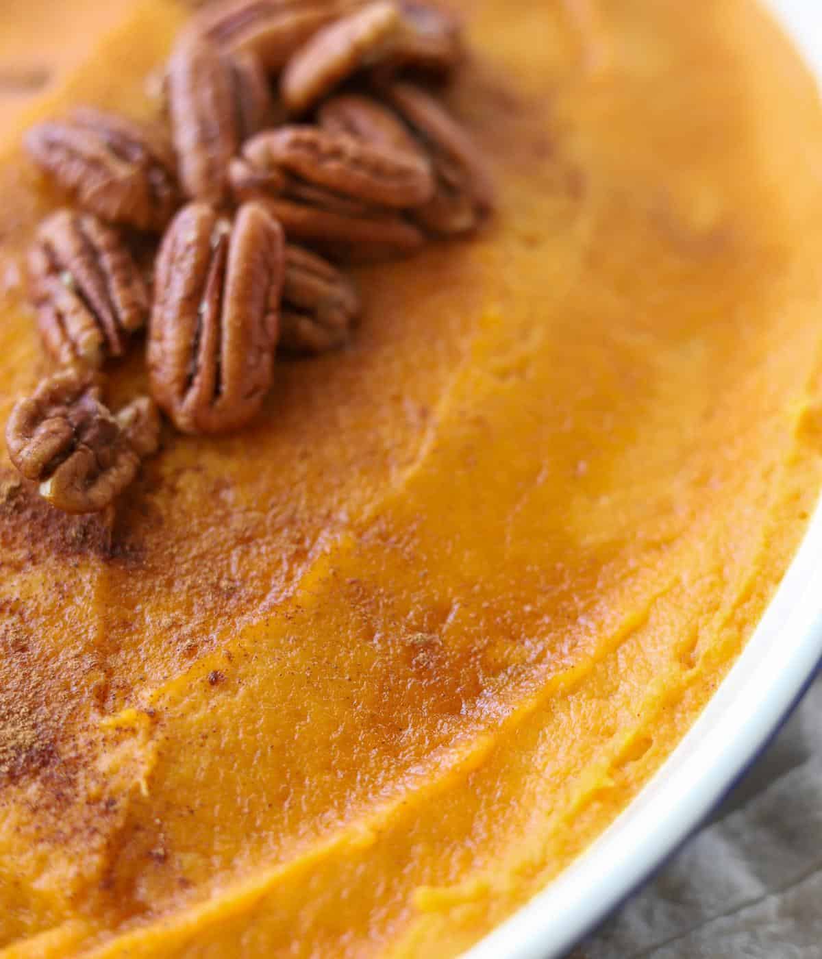 close up view to show smooth texture of whipped sweet potatoes in casserole dish
