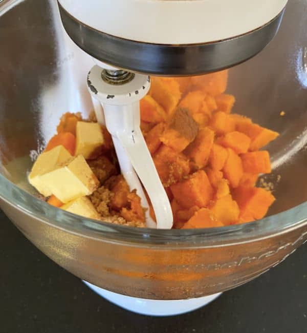 butter brown sugar and cinnamon mixing in stand mixer with potatoes
