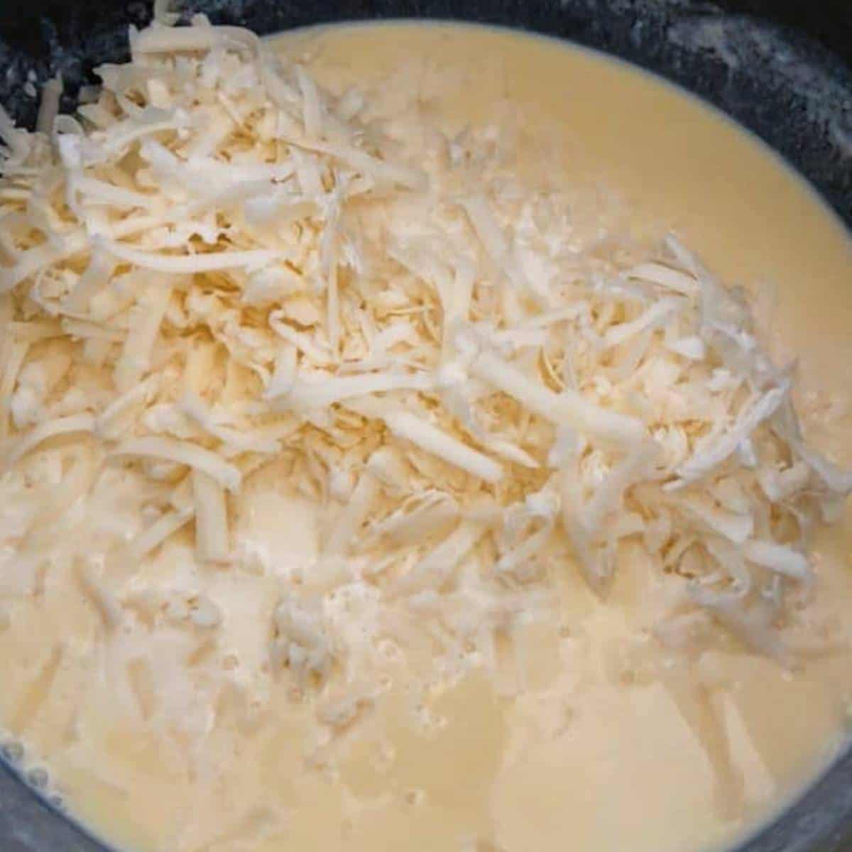Cheese in roux in skillet macaroni and cheese.
