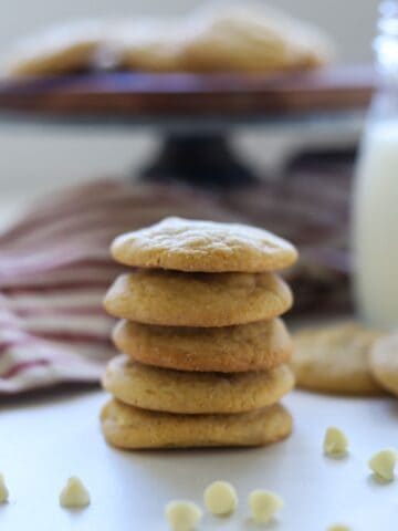cookies stacked in front of milk and cake stand