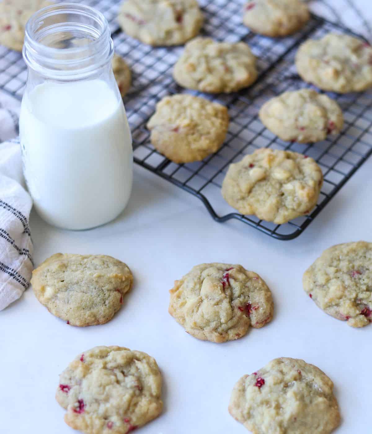 cookies on baking rack with glass of milk