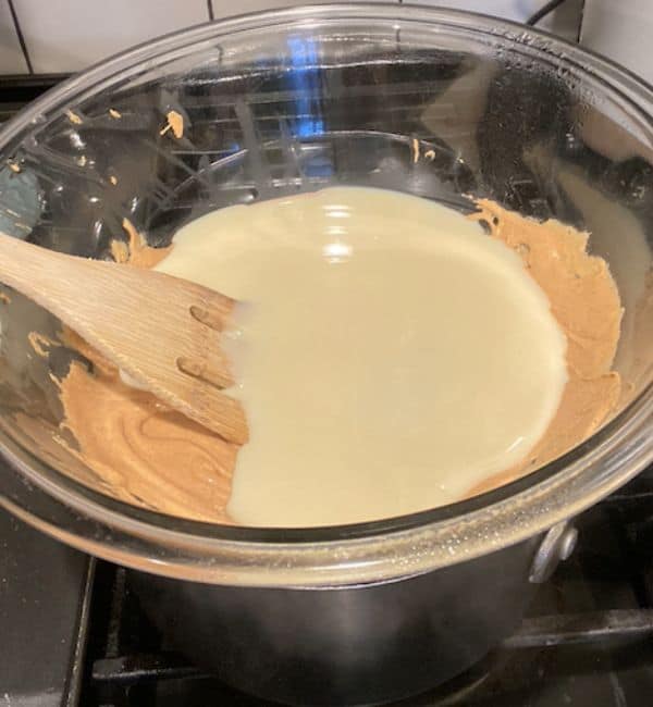 sweetened condensed milk added to double boiler over peanut butter chips
