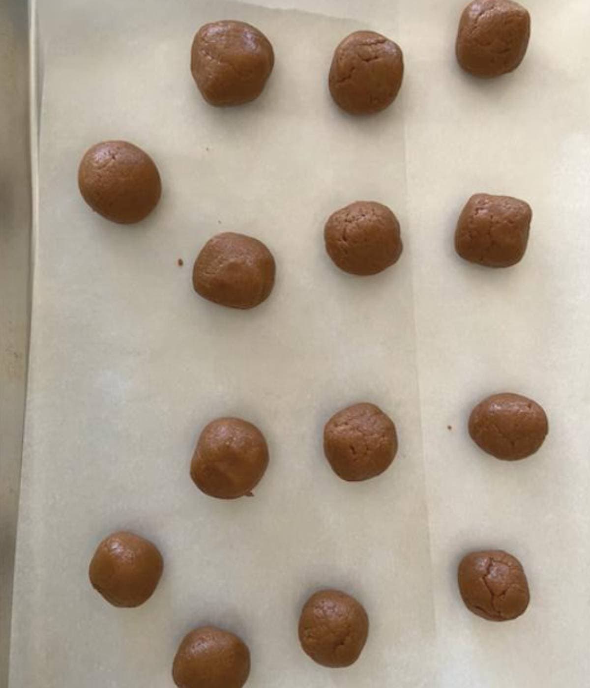 Biscoff filling rolled into balls and placed on parchment lined cookie sheet.