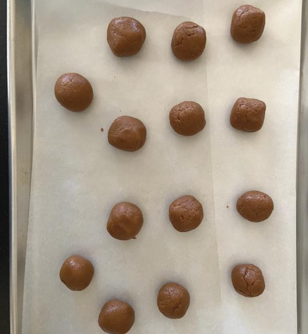 truffles rolled up on parchment paper cookie sheet