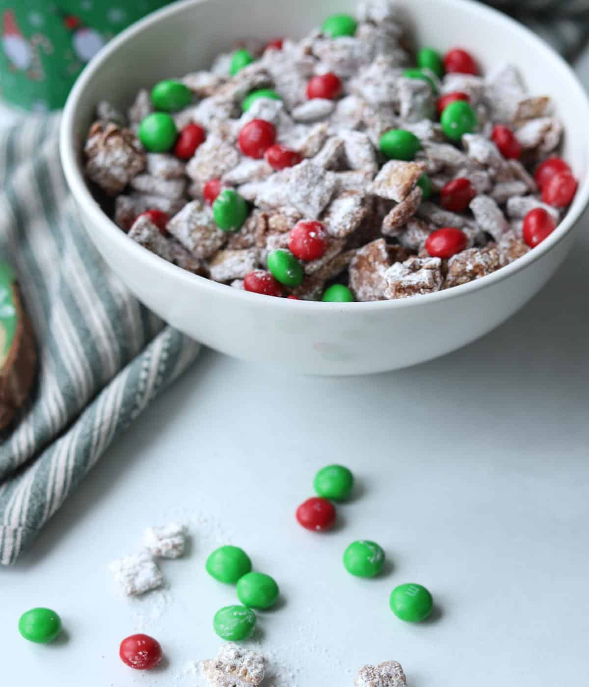 puppy chow in white bowl with m&ms in front