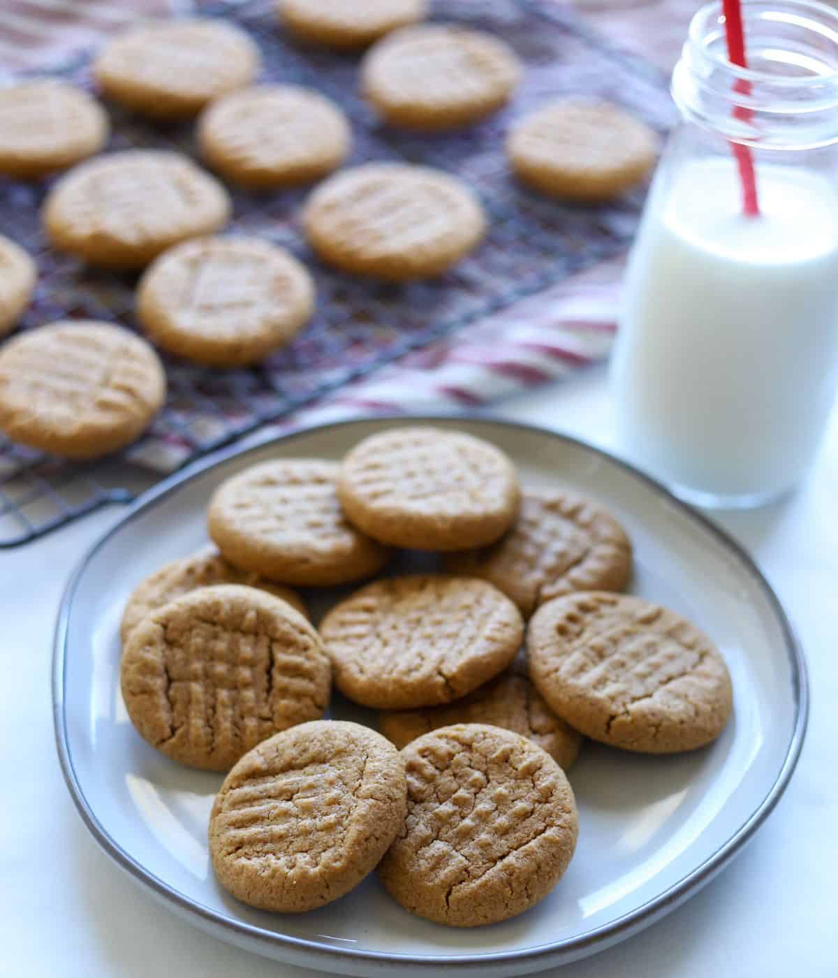 peanut butter cookies on plate with milk and cookies in the background