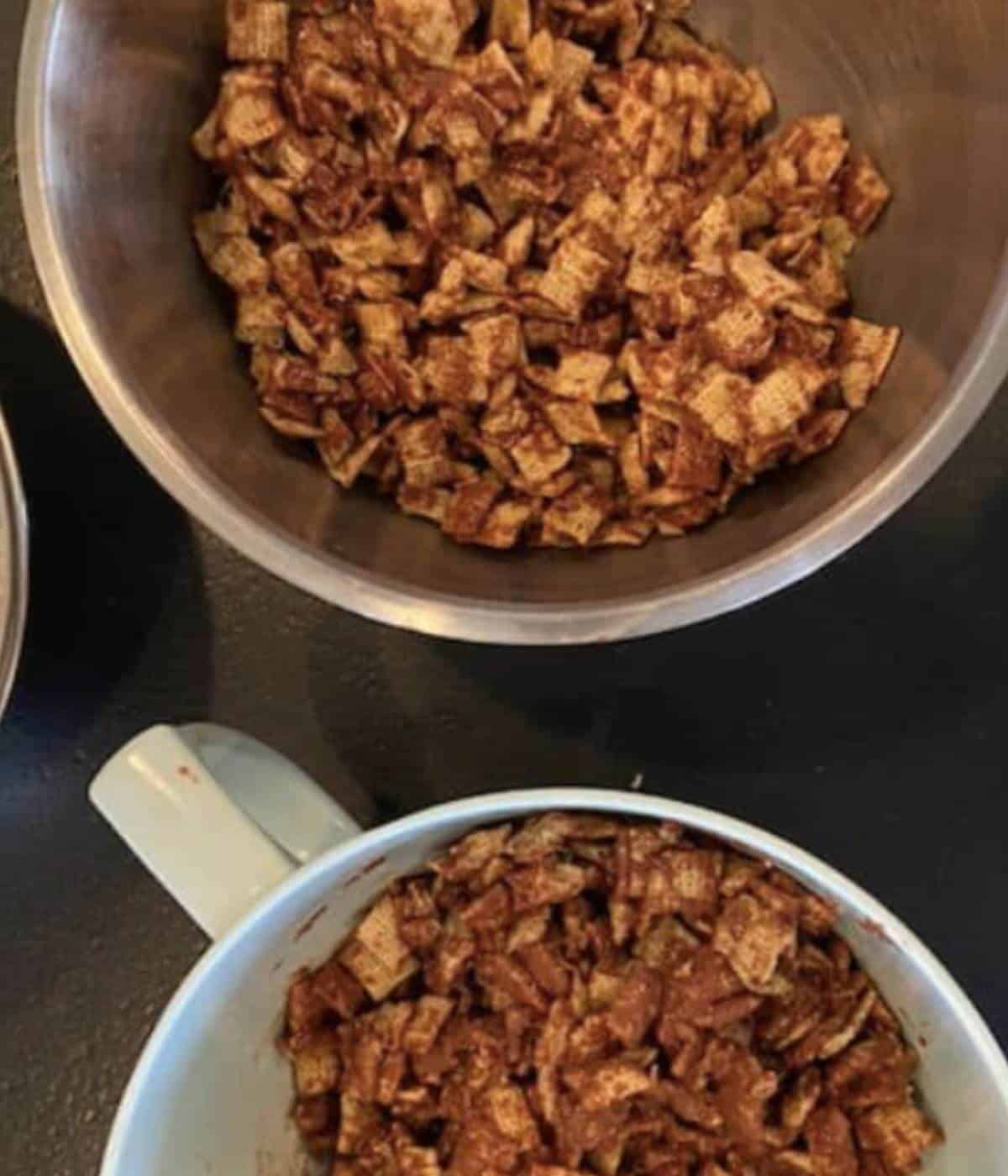 Chex separated into two bowls with chocolate.