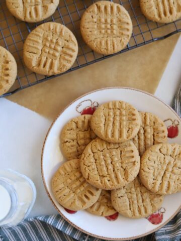 Peanut butter cookies on plate with side of milk.