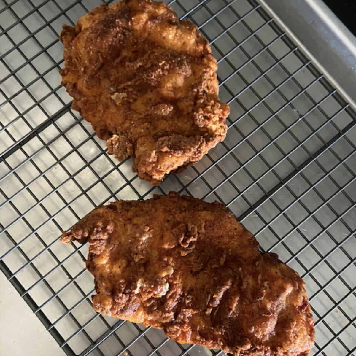 2 chicken breast finished frying on rack