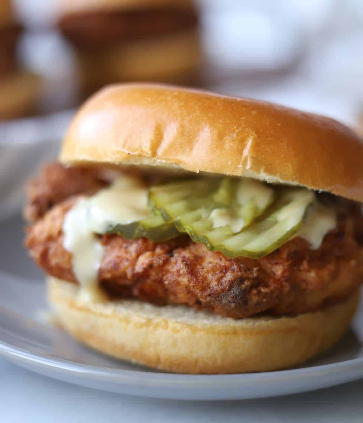 chicken burger on a brioche with pickles and honey mustard