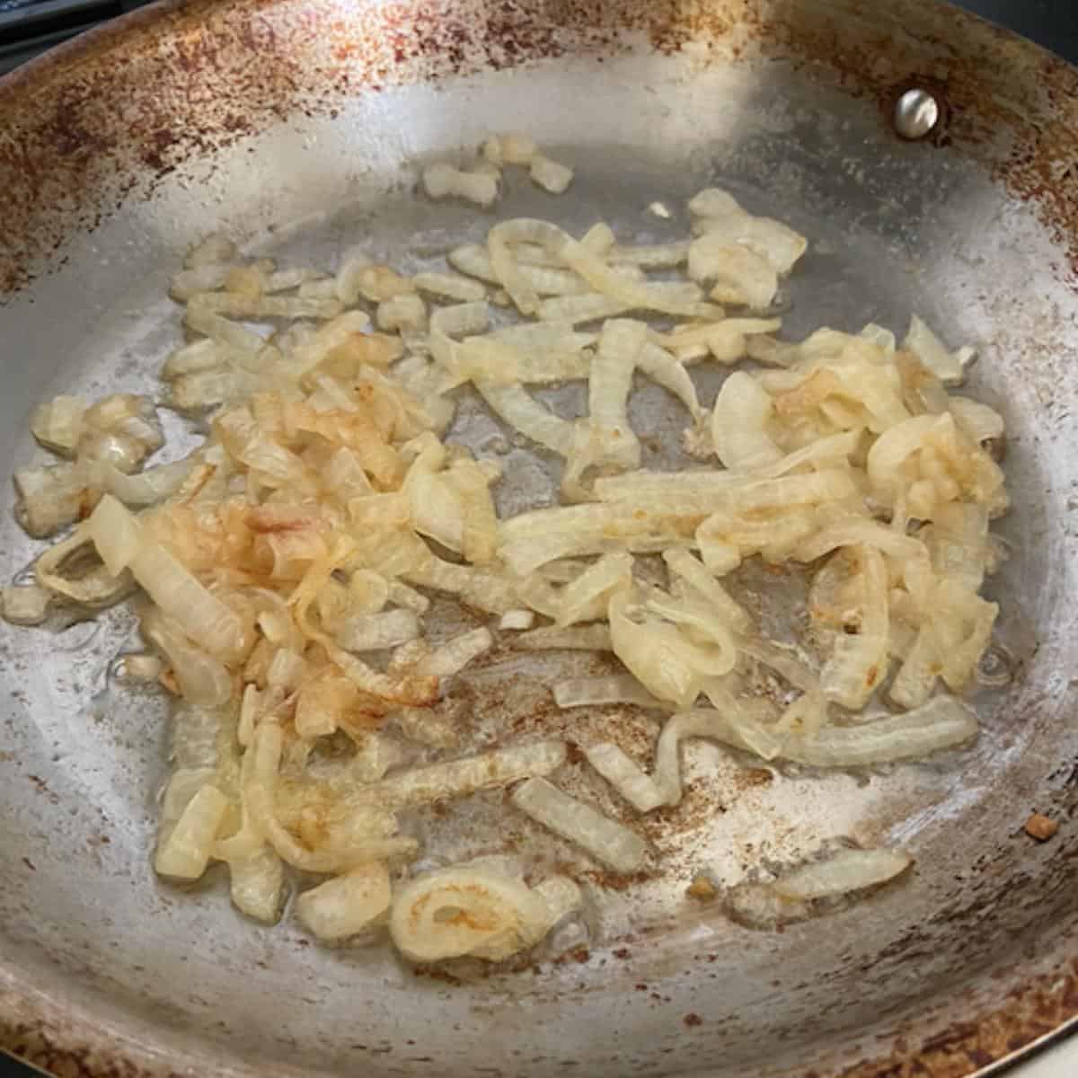 onions caramelized in stainless steel skillet