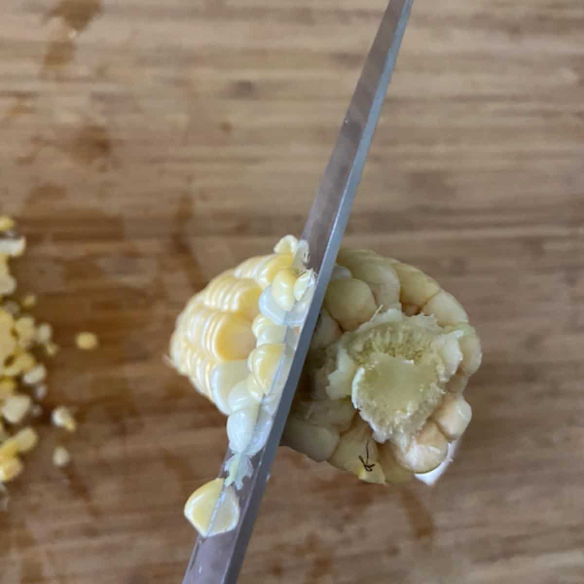 knife cutting corn off the cob