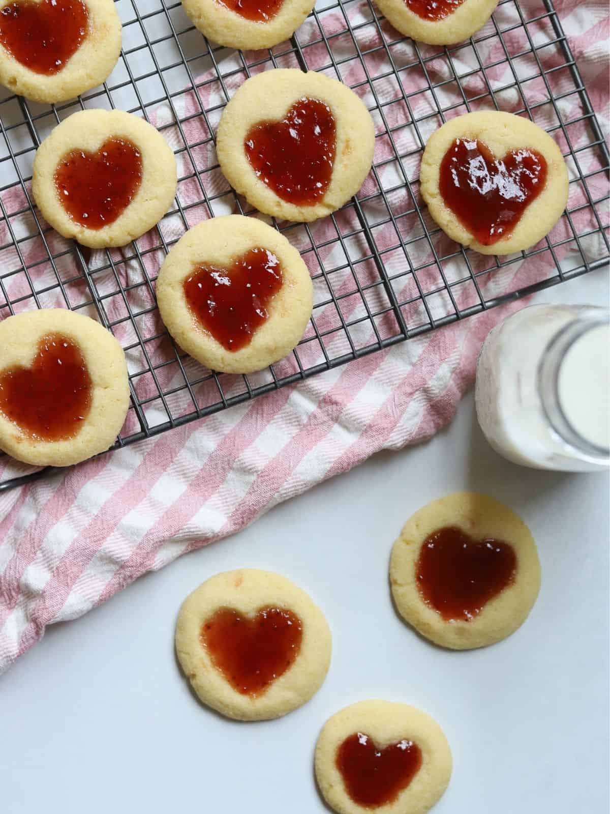 thumbprint cookies on baking rack with milk in glass jar