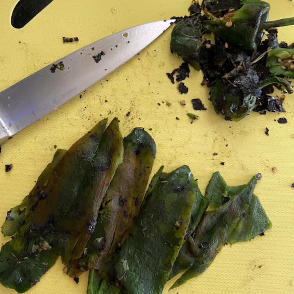 poblanos with skin, seeds and stems removed on cutting board