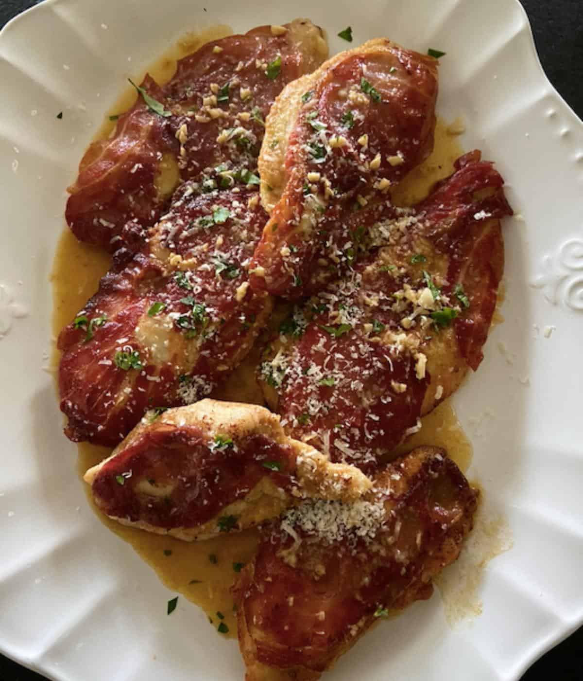 chicken prosciutto on white serving plate