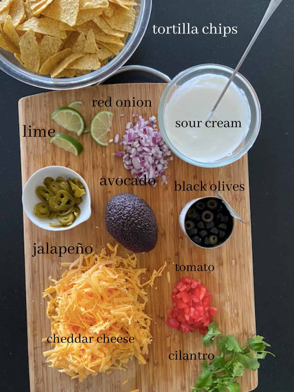 vegetarian nacho ingredients on cutting board with text