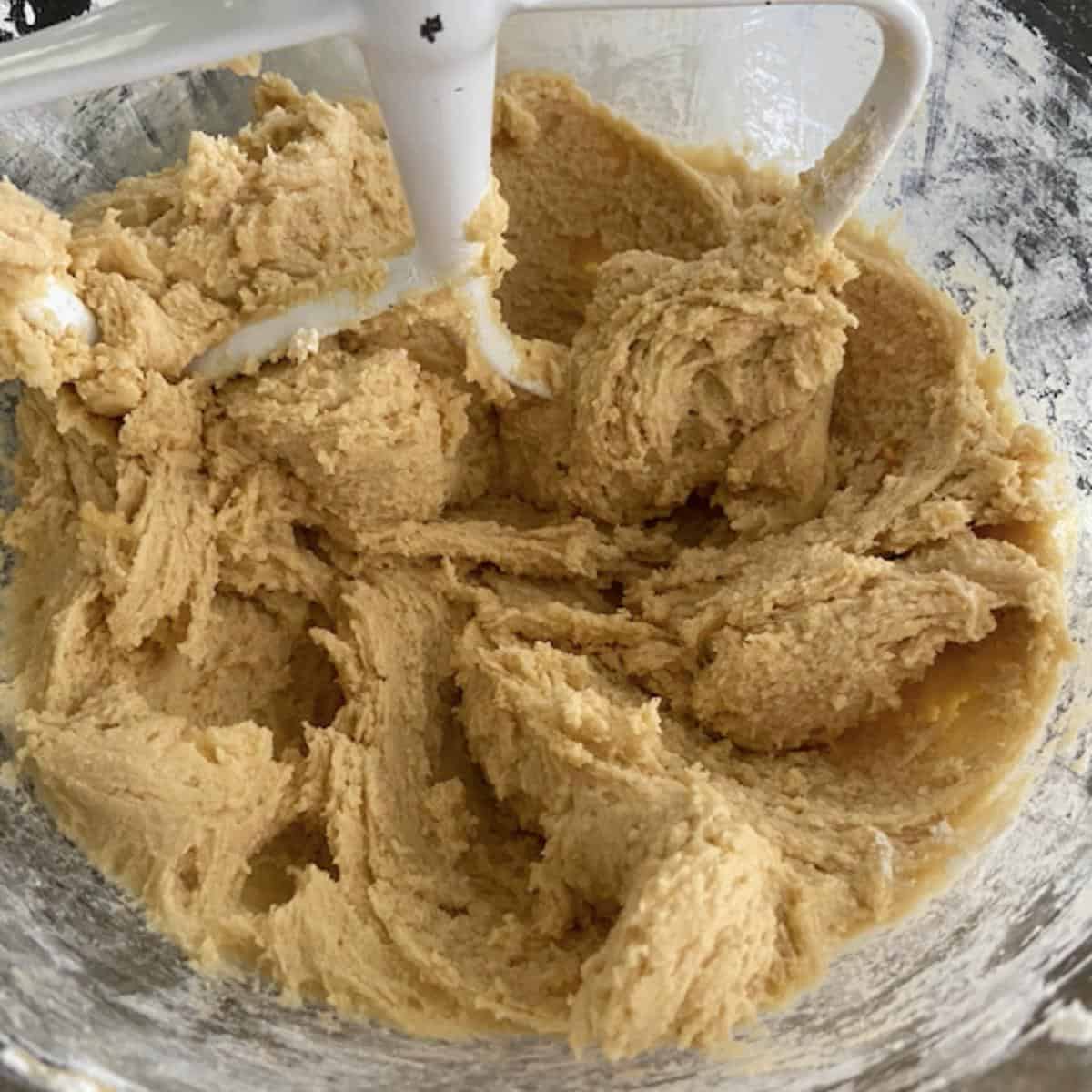 cookie dough in stand mixer bowl with beater attachment