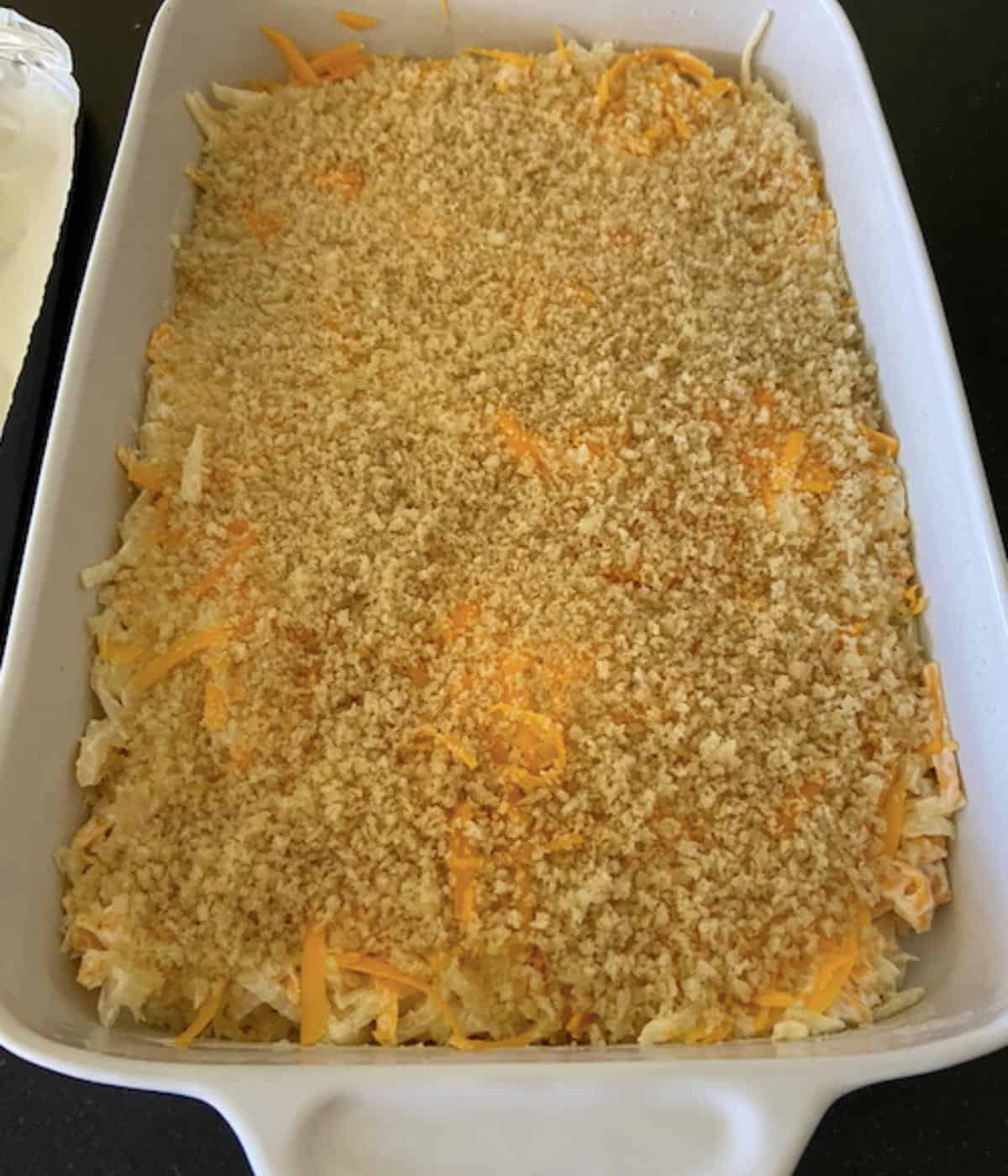 cheesy potato casserole in 9x13 dish ready to bake