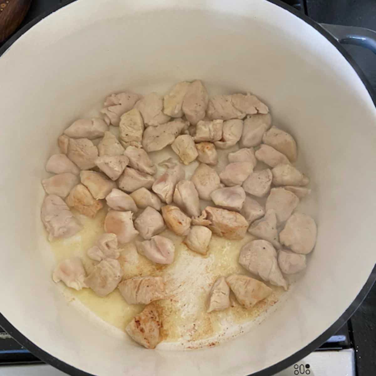 chicken cooking in dutch oven