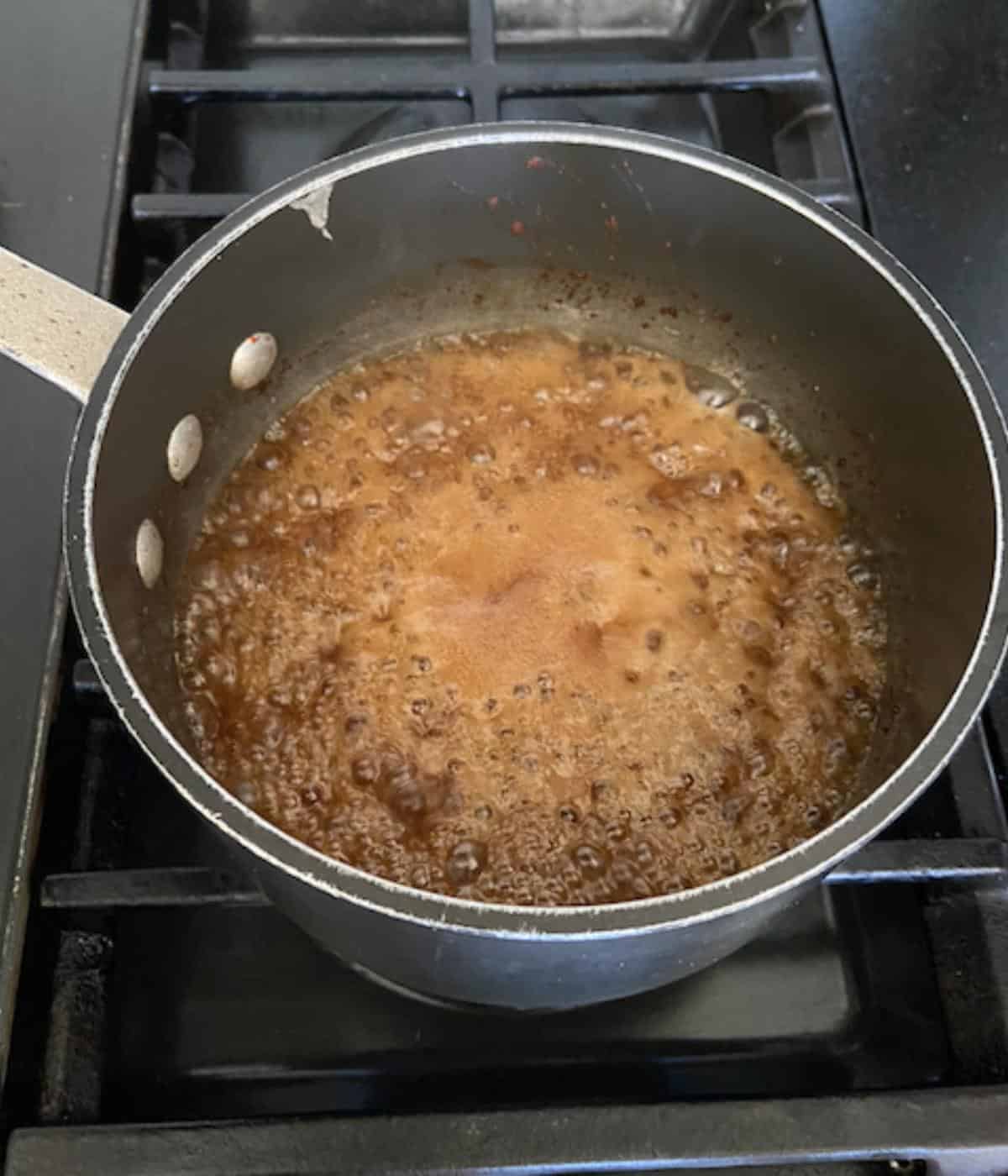 pineapple glaze coming to a boil in saucepan