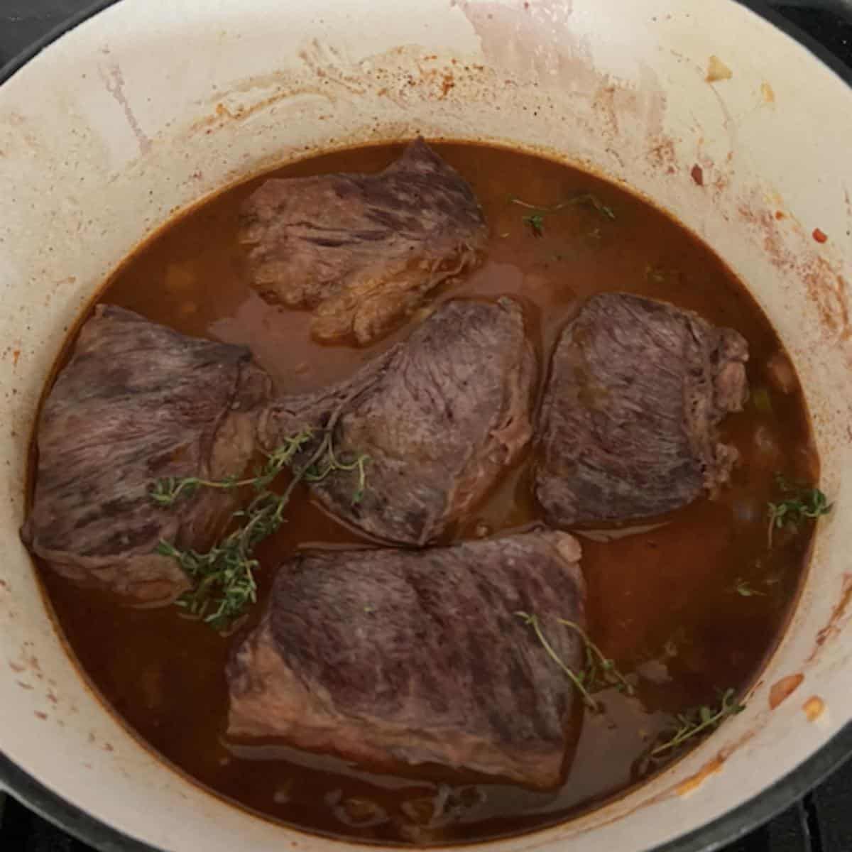 Short ribs in dutch oven ready to bake.