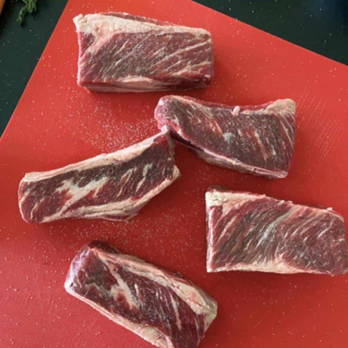 Boneless beef short ribs on cutting board.