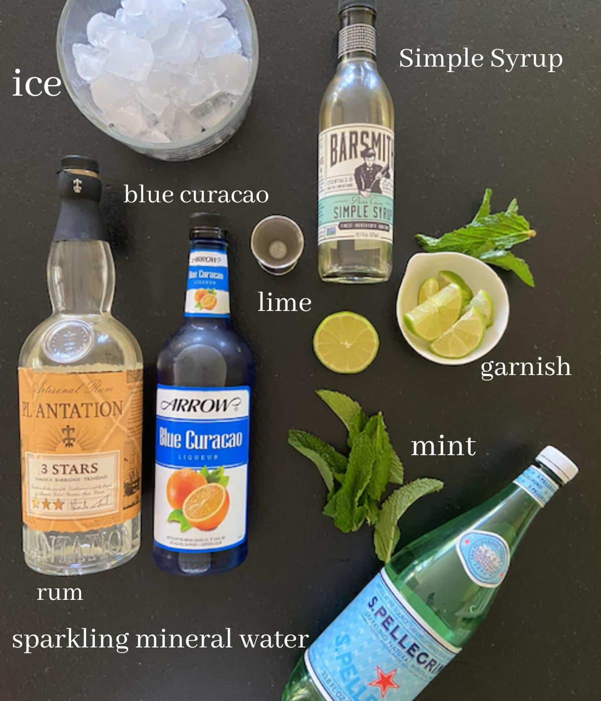 blue mojito ingredients on black countertop with text