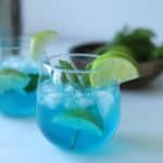 blue curaçao mojito in glass with lime