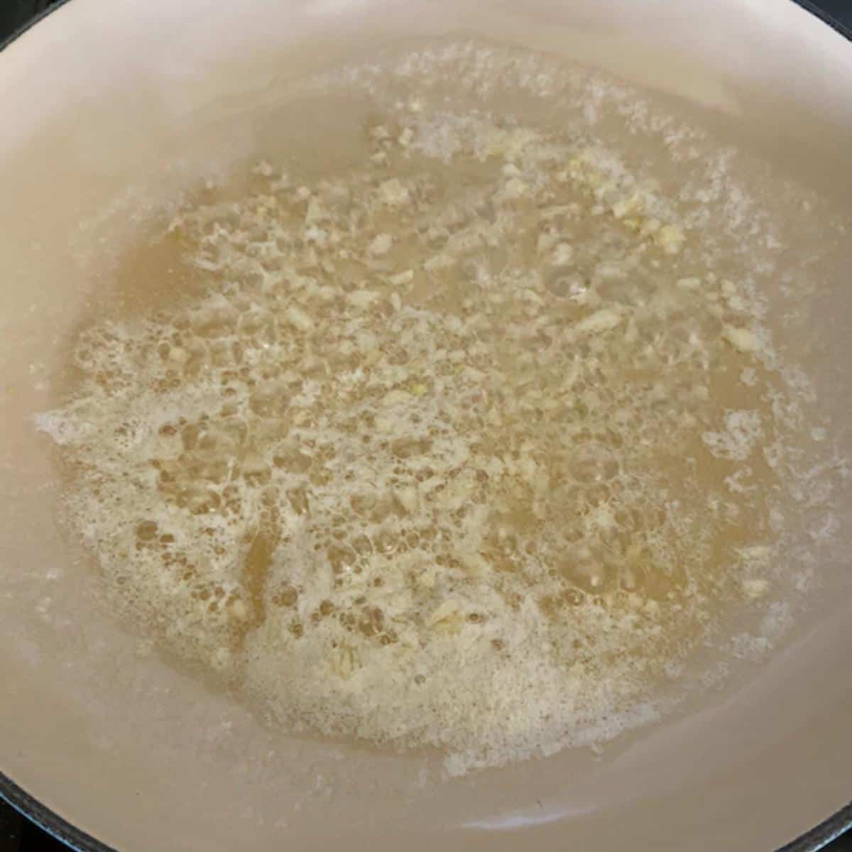 Garlic and butter sautéing in pan.