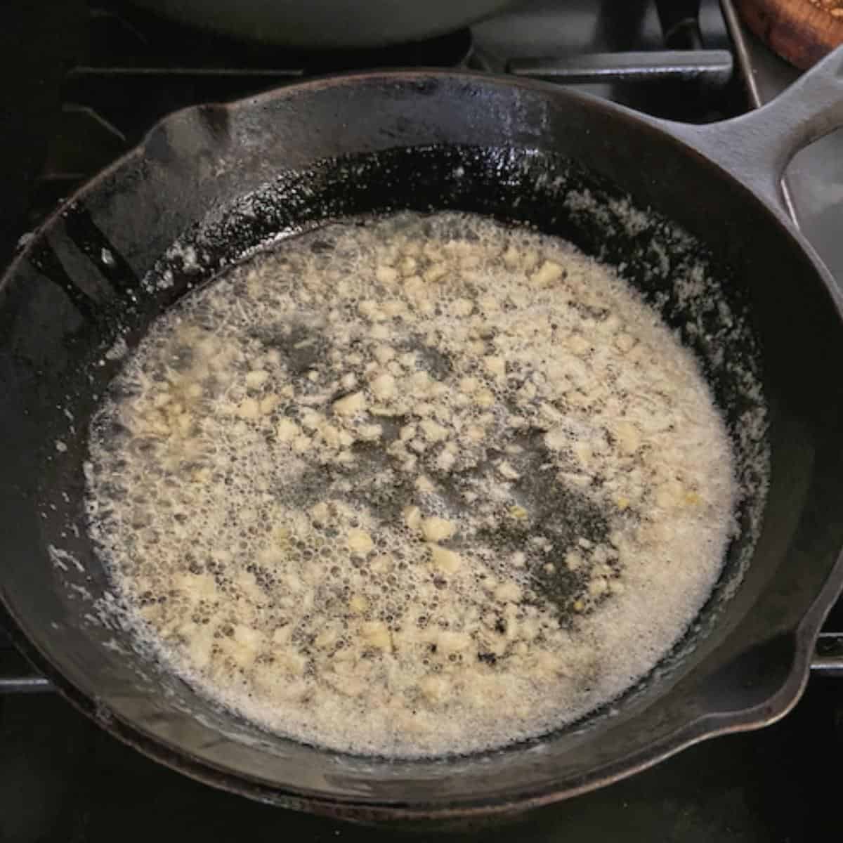 garlic butter cooking in skillet