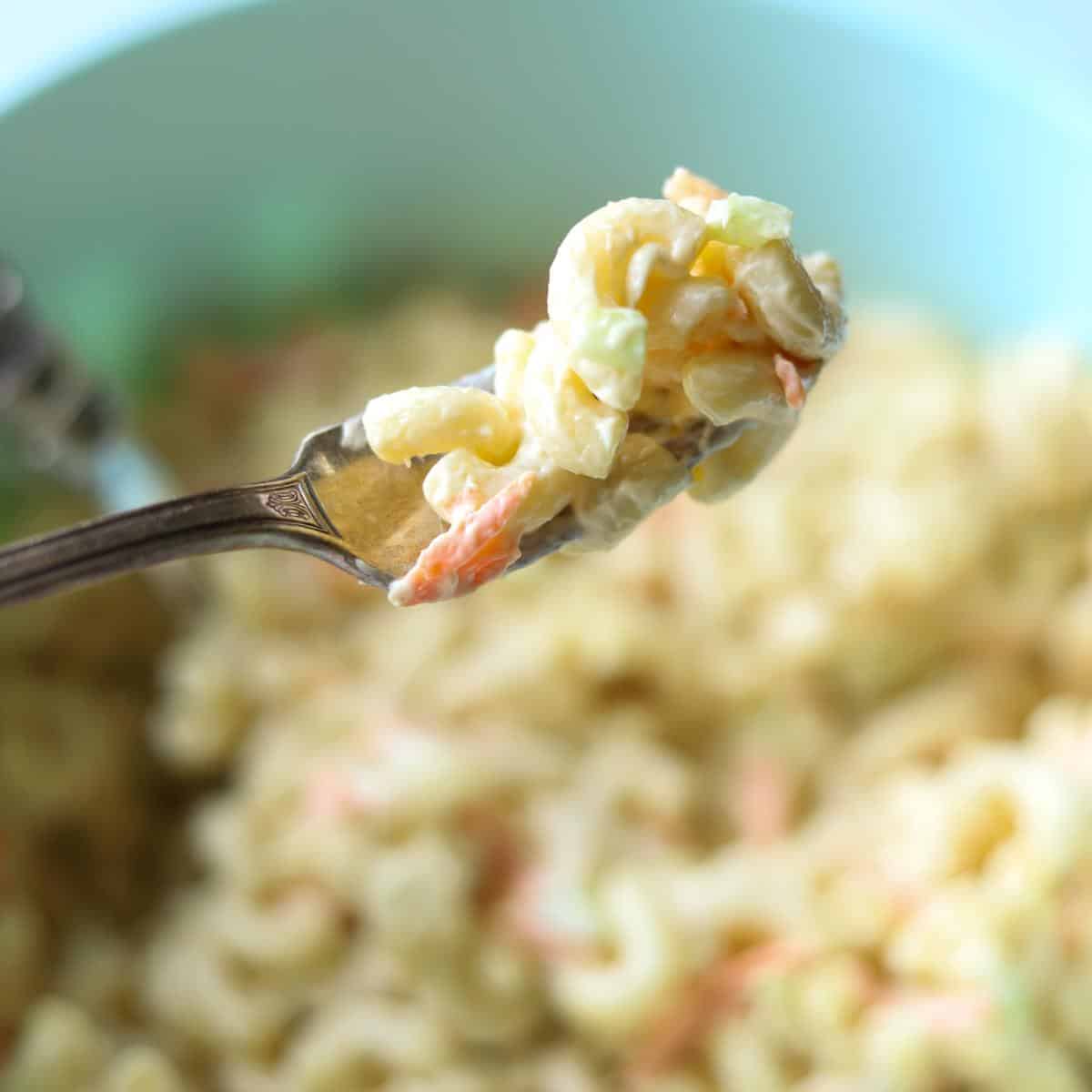fork holding macaroni salad