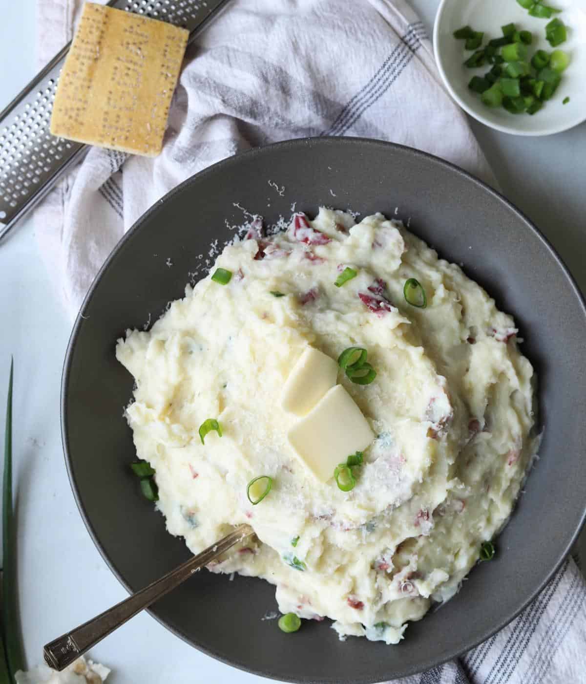 bowl of red skinned mashed potatoes topped with butter