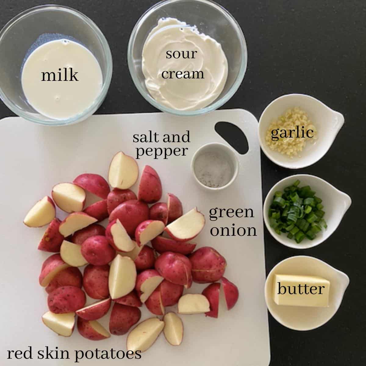 ingredients for mashed red skinned potatoes on countertop with text