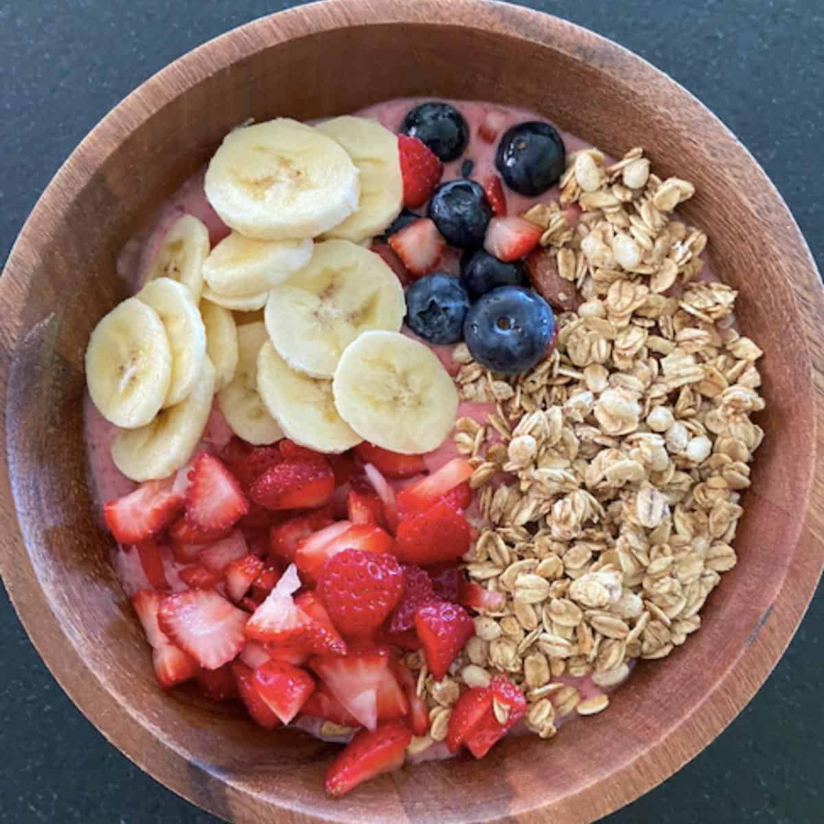 smoothie bowl toppings added onto smoothie bowl