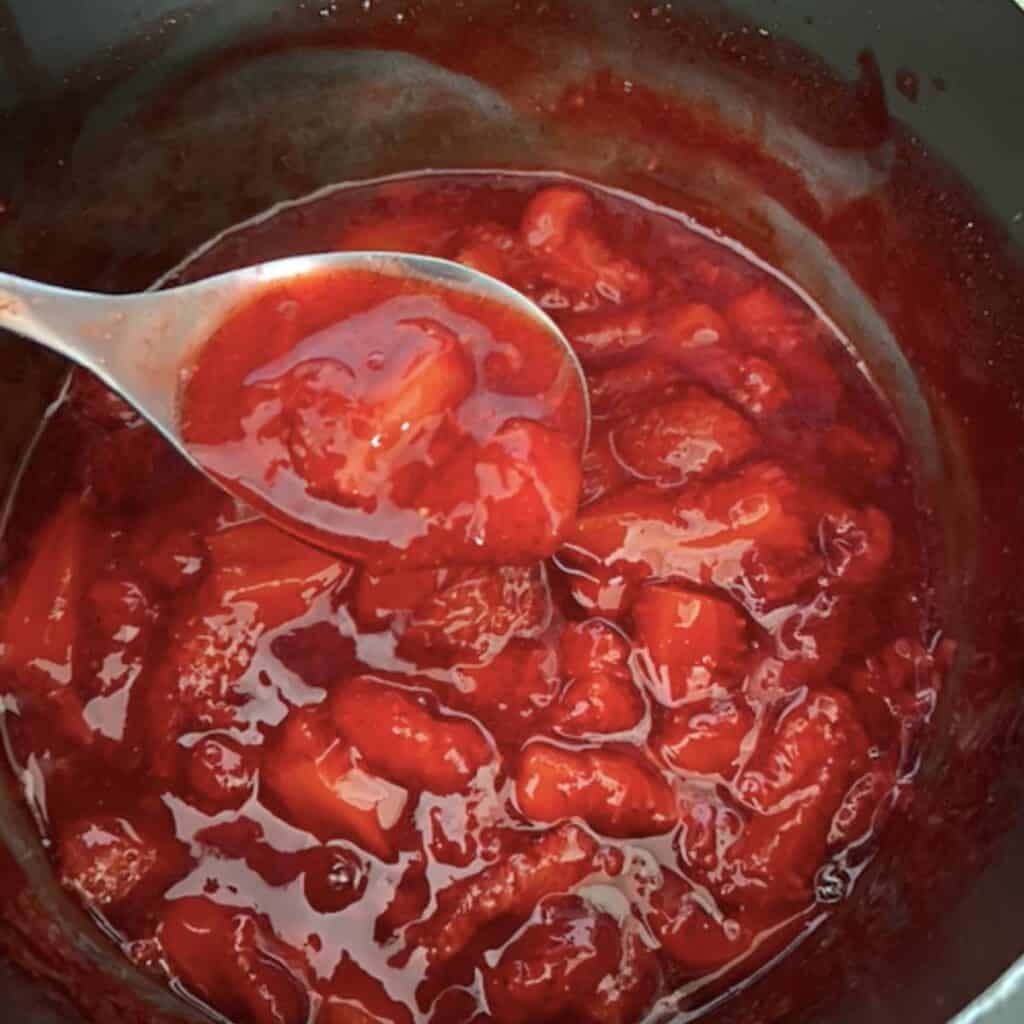 Finished strawberry compote sauce in pan.