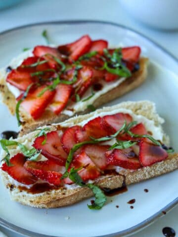 Strawberry ricotta toast topped with basil and balsamic.