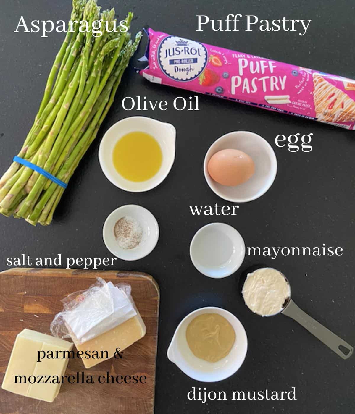Asparagus puff pastry tart ingredients on countertop with text.