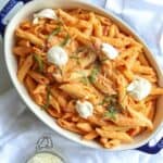 Four cheese pasta in casserole dish topped with dollops of ricotta cheese.