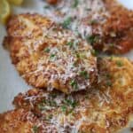 Crispy Chicken Romano topped with parsley and cheese.