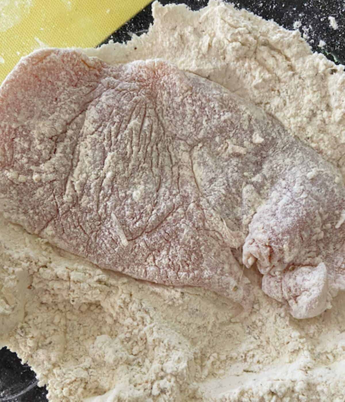 Chicken breast dredged in flour.