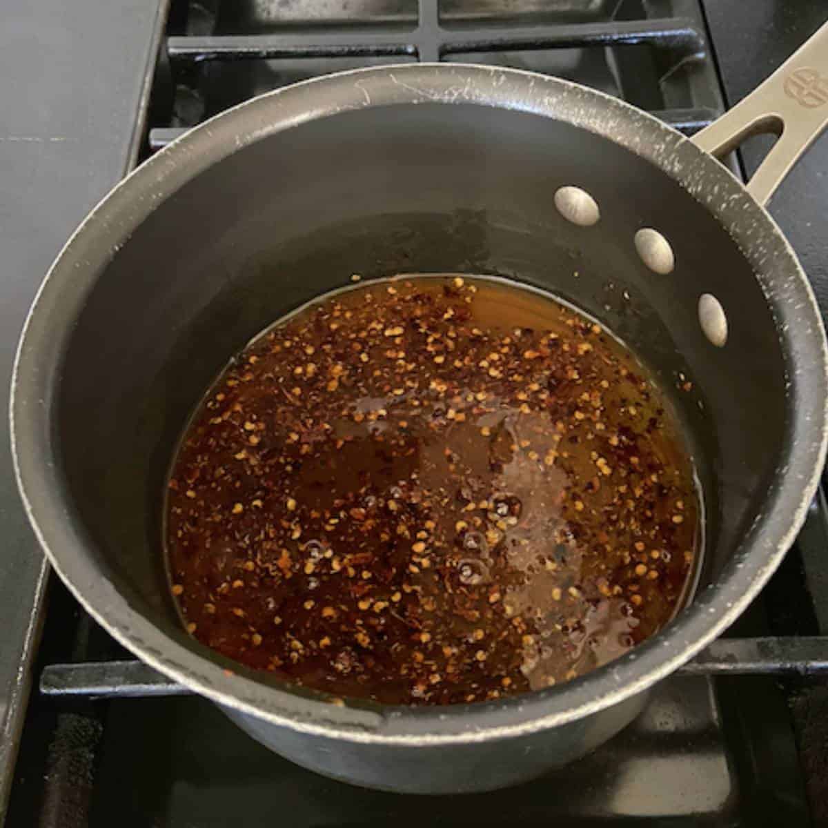 Spicy honey infusing in pot.