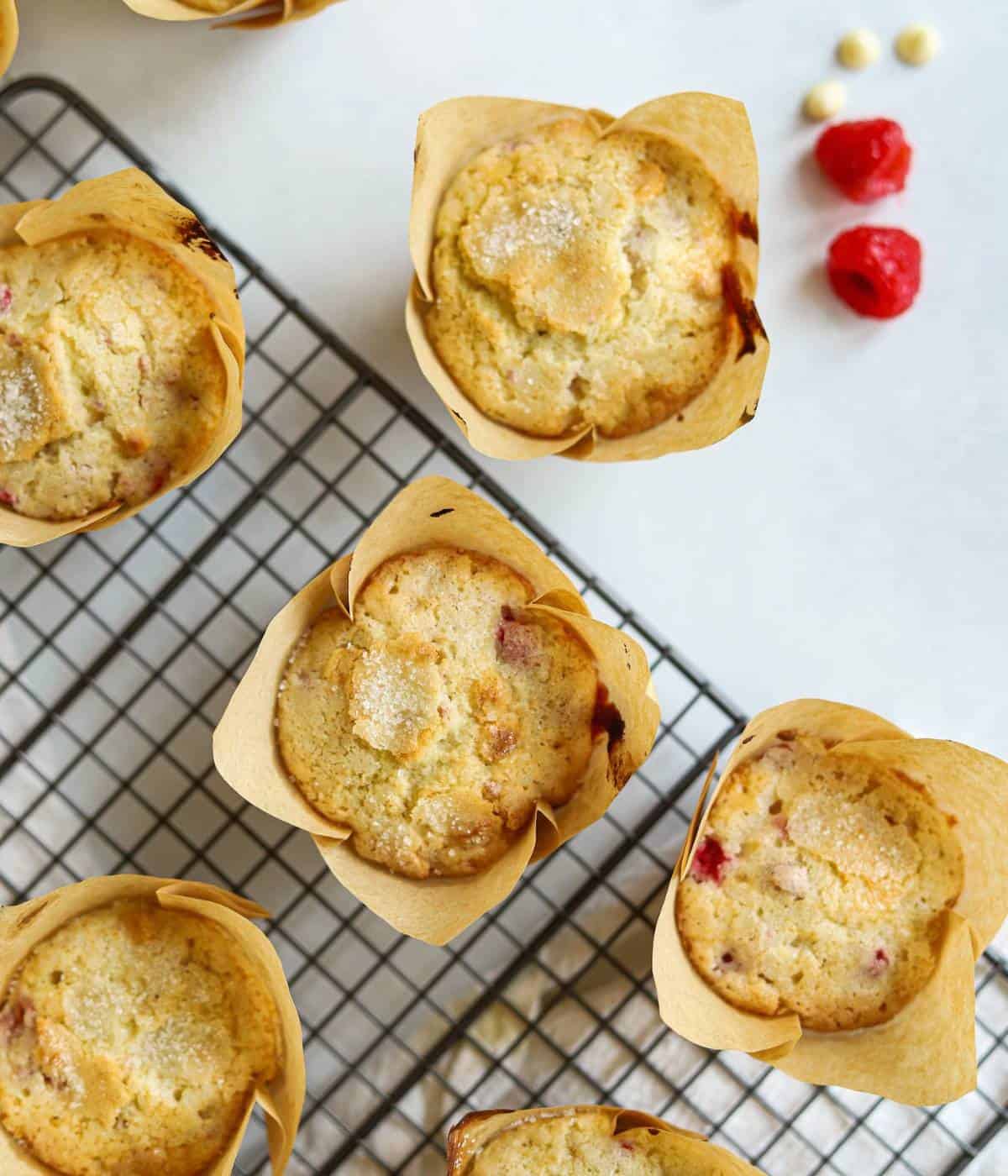 Raspberry muffins on baking rack.